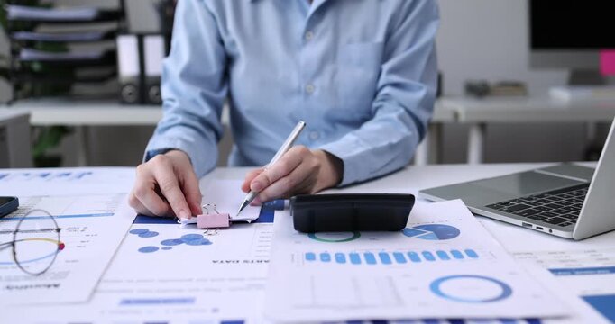 Professional analyzing financial data graphs, charts on laptop display at a modern workspace. Financial analysis or business evaluation concept
