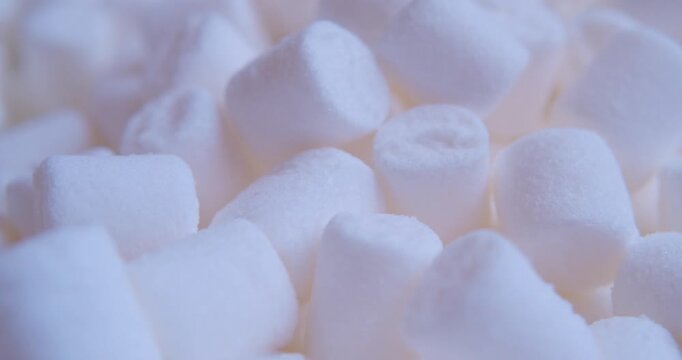 Close-up of many pieces of White Marshmallow. Sweet food. Macro with shallow depth of field.