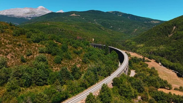 Scenic drone footage of canfranc railway viaduct in the spanish pyrenees mountains