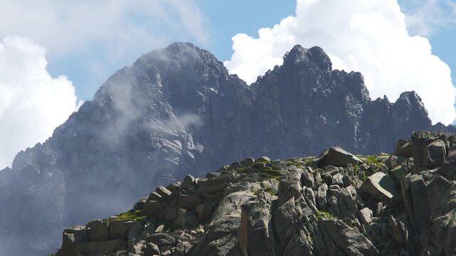 Mount Kinabalu Malaysia summit rises above clouds with rugged stone and tropical alpine drama. Misty layers, craggy relief, lofty elevation create iconic Borneo scenery under humid skies.