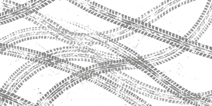 Black tire tracks and vehicle wheel marks on a flat surface