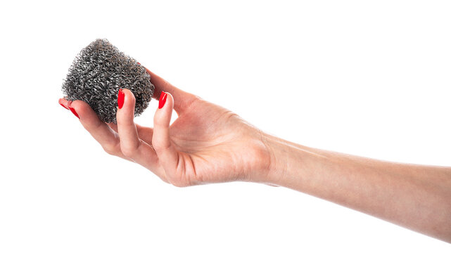 Metal kitchen sponge in the hand isolated on a white background 