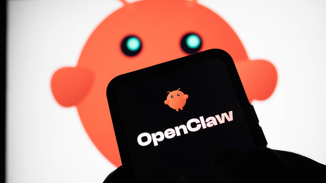 Closeup of a smartphone screen displaying the openclaw logo with a large, blurred android mascot icon in the background