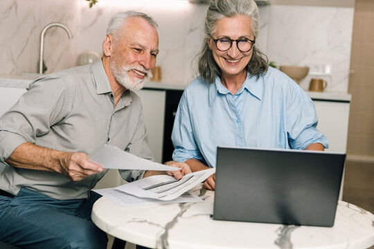 Couple discusses family budget and bills while using laptop at home