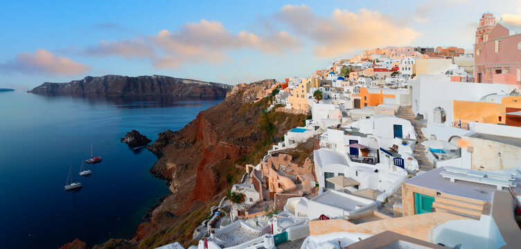 traditional greek village Oia of Santorini, street against deep Aegan sea and caldera, Greece, web banner format