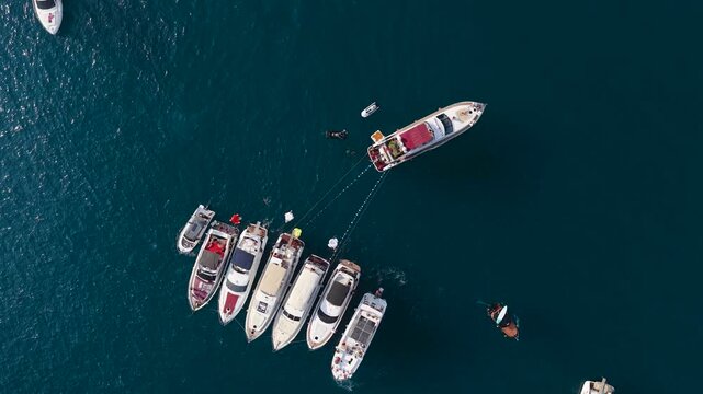 Aerial Video Yacht Party with Flyboard Performance Between Boats and Jet Ski Driving Around in Blue Water
