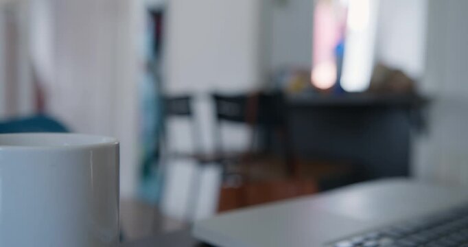 Morning Coffee and Workspace: A quiet moment of work, featuring a pristine mug of coffee alongside an open laptop, hinting at a productive day ahead in a cozy environment.