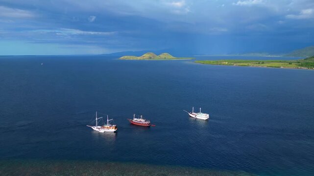 Traditional phinisi boats anchored komodo island. Best aerial view drone