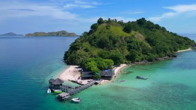 Komodo island paradise beach, jetty, turquoise ocean. Smooth aerial view drone