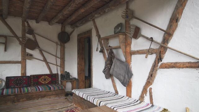 Traditional Balkan village house balcony and garden decor, rustic porch panorama view. Historic peninsula homestead veranda ornaments, handmade tools, textiles, timber beams, quiet courtyard scene.