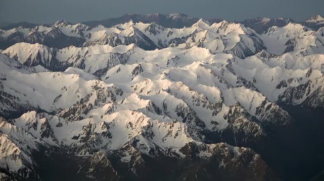 Aerial view of snowy Pyrenees peaks in spring, Spain France border mountains, Europe. Overhead panorama showing ice coated summits during melt season across iberian gallic highlands.
