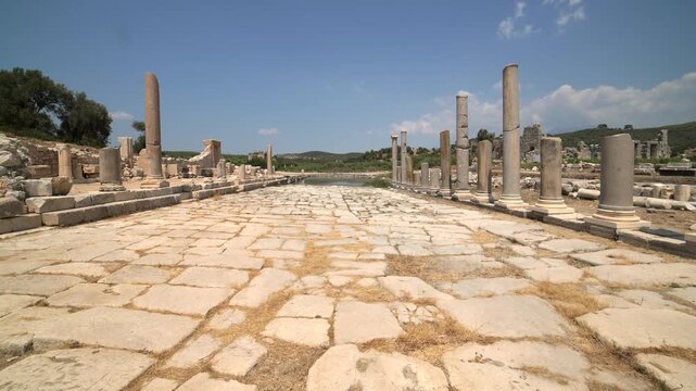 Patara ancient city colonnaded street ruins in Turkey under bright sky, classical stone avenue. Lycian archaeological site with Roman columns, Greek heritage, Byzantine legacy, early civilization.