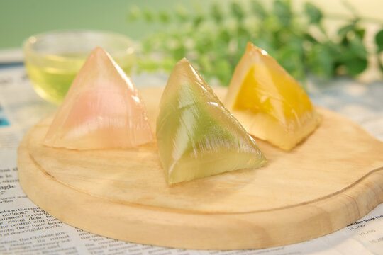 Colorful crystal rice dumplings on wooden tray with tea