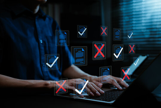Document review verification and error check concept. Professional using laptop with files, approved check marks, rejected red crosses, compliance screening, quality control, digital auditing workflow