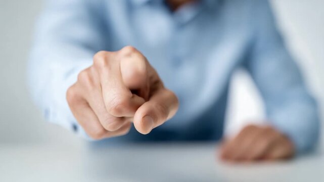 Focused Finger: A close-up shot of a person's hand, extending a finger in a gesture of direction or accusation. The image highlights the intensity and focus of the gesture.