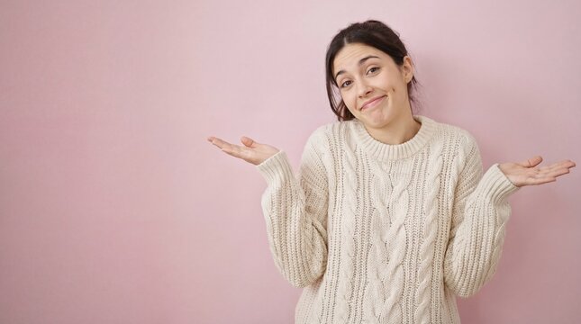 confused caucasian woman shrugging shoulders with palms up against pink background. concept of uncertainty, ignorance, doubt. banner, website header, copyspace.