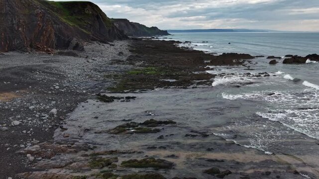 High tide reaches the beach at Sandymouth Bay Cornwall