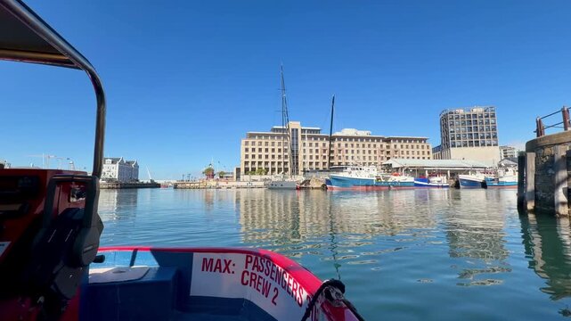 Cape Town, South Africa - January 31, 2026: Hop-on hop-off water boat tour at Cape Town&rsquo;s VA Waterfront, sunny weather, blue sky, relaxed holiday atmosphere with tourists enjoying harbor views. 