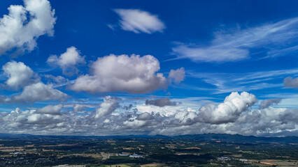 A wide-angle composition that highlights the contrast between a dynamic, cloud-laden sky and the vast, varied vegetation at its base. © Roberto