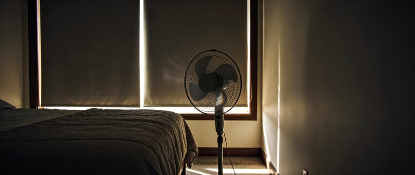 Room with Closed Curtains and Oscillating Fan