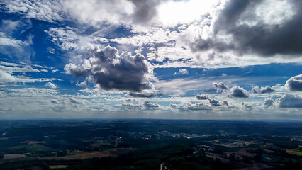 A wide-angle composition that highlights the contrast between a dynamic, cloud-laden sky and the vast, varied vegetation at its base. © Roberto