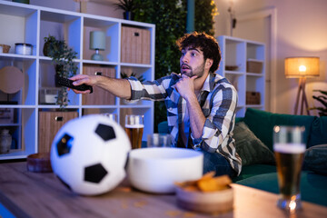 Young man watching football game at home reacting © Zoran Jesic