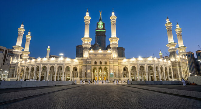 Illuminated Masjid al Haram and Abraj Al Bait Clock Tower at Night in Mecca Saudi Arabia
