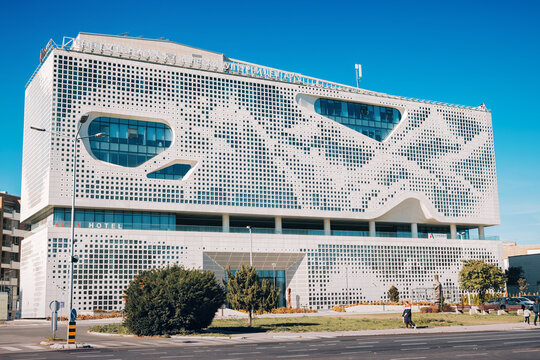 25 October 2025, Belgrade, Serbia: Chinese Cultural Center building featuring contemporary perforated facade and unique window shapes