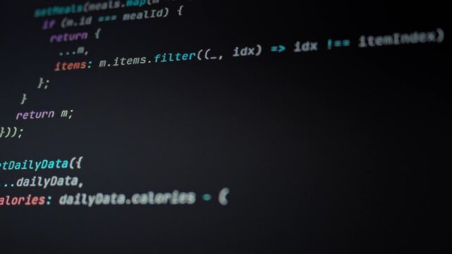Programmer observes their computer monitor where AI automation algorithms execute through endless lines of code, showcasing how intelligent software transforms computational processes across networks