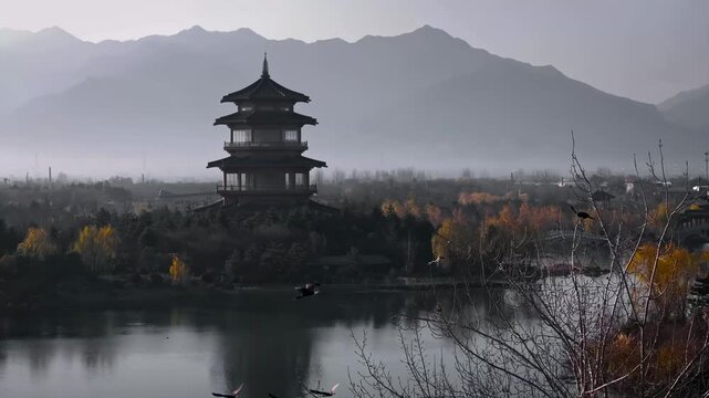 Ancient Chinese pagodas by a tranquil lake with mountains
