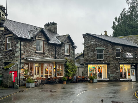 Grasmere, Cumbria, England, UK - 03.11.25. Grasmere village street view in Cumbria, Lake District. Rainy autumnal day in Lake District, beautiful colors of fall. Charming stone houses along the road. 