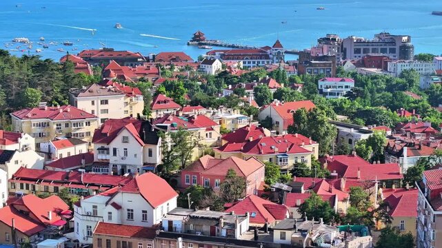 Parasailing and speedboats on blue sea with modern coastal city skyline