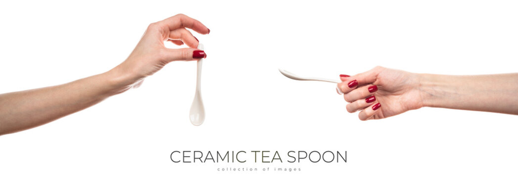 White ceramic tea spoon in female hand isolated on white background.