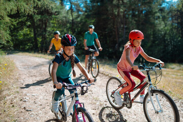 Fototapeta premium Active family enjoying biking adventure in scenic landscape.