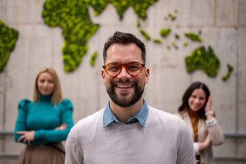 Smiling businessman with global business team in office © Migma_Agency