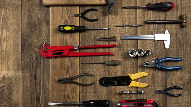 Assortment of professional construction tools arranged neatly on a rustic wooden background for home repair and renovation