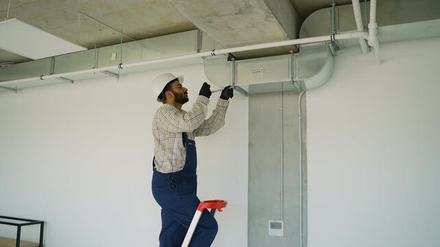 Ventilation system installer assembling air conditioning ducts