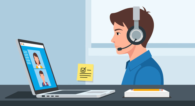 Man wearing headset sitting at desk with laptop computer