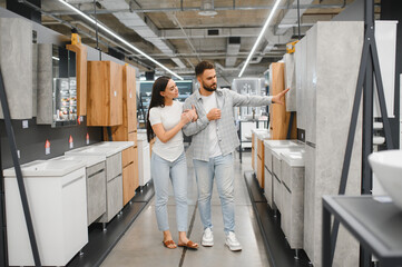 Plakat Couple choosing bathroom furniture in home improvement store