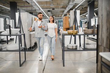 Fototapeta premium Couple choosing bathroom fixtures for home renovation