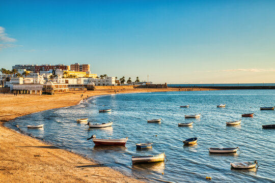 Golden hour at Playa de la Caleta with Traditional Fishing Boards, Cadiz