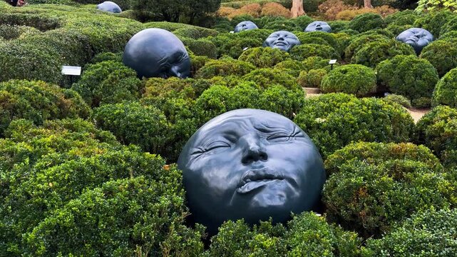 Big heads in the Gardens of Etretat (Les Jardins d Etretat) is a topiary garden located in the English Channel town of Etretat, Normandy, France, October 15, 2025. High quality 4k footage