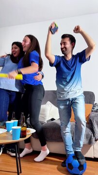 Group of italian fans celebrating a goal while watching football game at home