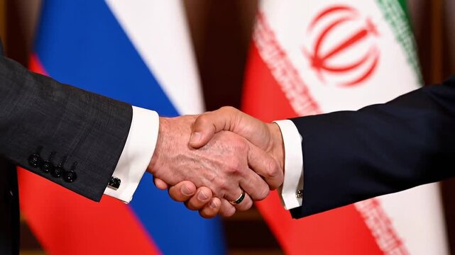 Handshake between two businessmen in front of Russia and Iran flags