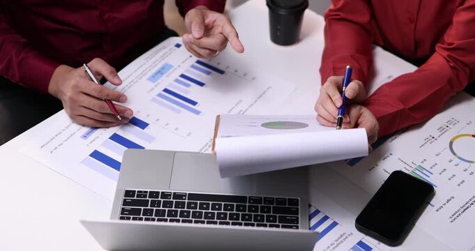 Team of business analysis documents in action office setting report generation professional environment strategic planning