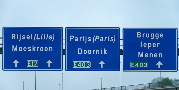View of a French and European autoroute with overhead directional signs pointing to major cities like Paris, Bordeaux, Lille, Calais, showing lanes, traffic and motorway infrastructure, road signes