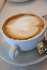 Obraz premium Barista made coffee cappuccino with foam heart with soy milk vegan drink