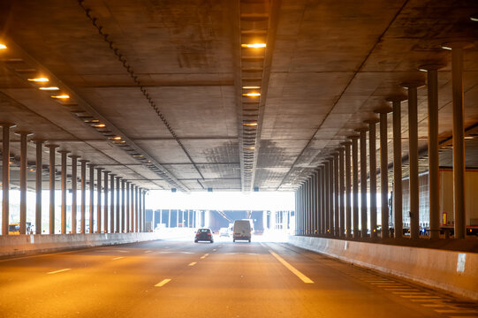 View of a French and European autoroute tunnel, showing lanes, traffic and motorway infrastructure, road signes