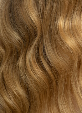 Blonde long wavy hair background. Curly honey colour hair. Haircare beauty products, shampoo and lotion. Hair Care Spa and wellness. Selective focus.