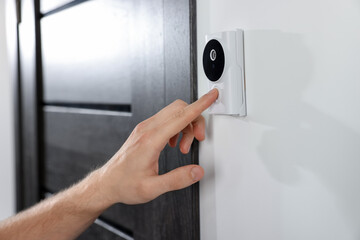Naklejka premium Man pressing button on intercom panel indoors, closeup